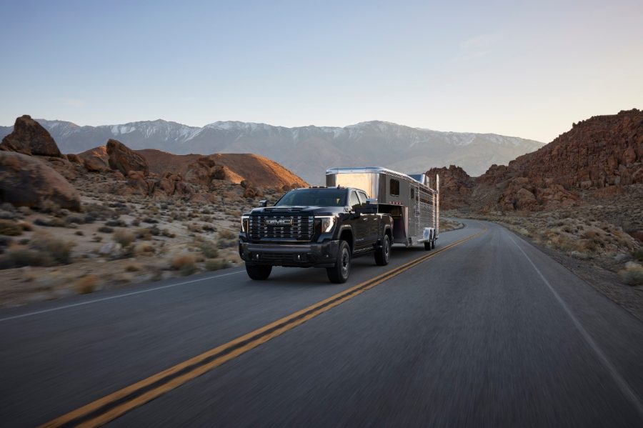 Preproduction 2027 GMC Sierra HD Denali Ultimate towing a trailer on a road